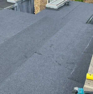 Flat grey roof with slight wear visible.