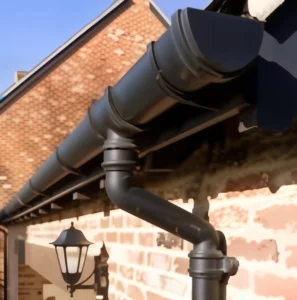 Black gutter on brick house exterior.