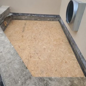 Plywood flooring on concrete balcony area.